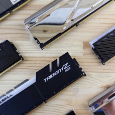 DDR5 RAM sticks laid out evenly on a polished wood table.